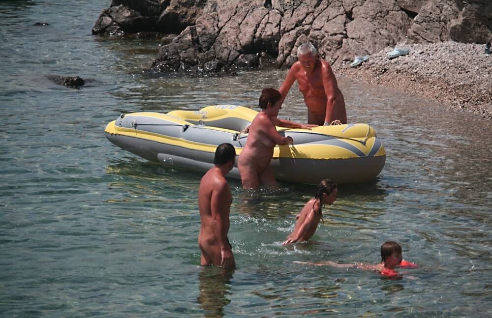 Lone Nudist in Yellow Boat photos - Health and well-being are enhanced through naturism and nudism