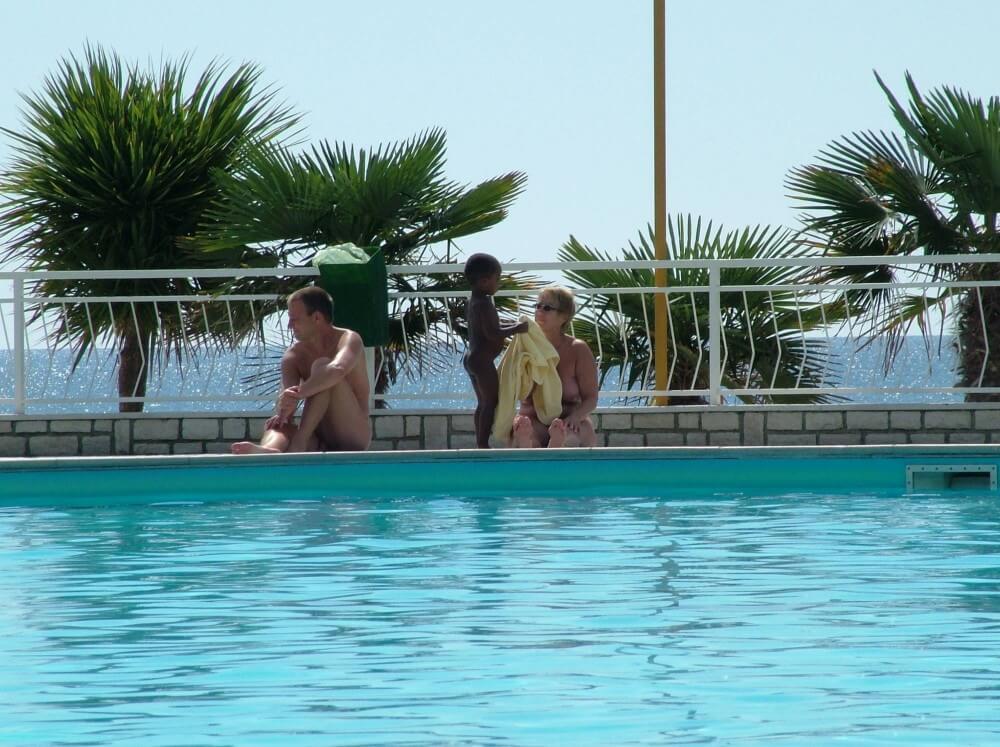 Photo of naturists in an outdoor pool - The Naked Human Body